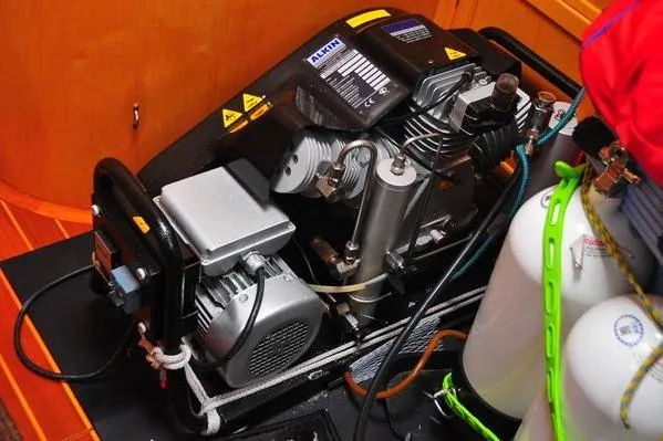 Raynad Yacht Photos Pics Engine room of 2000 Custom Steel Cutter World Cruiser with compressor and equipment.