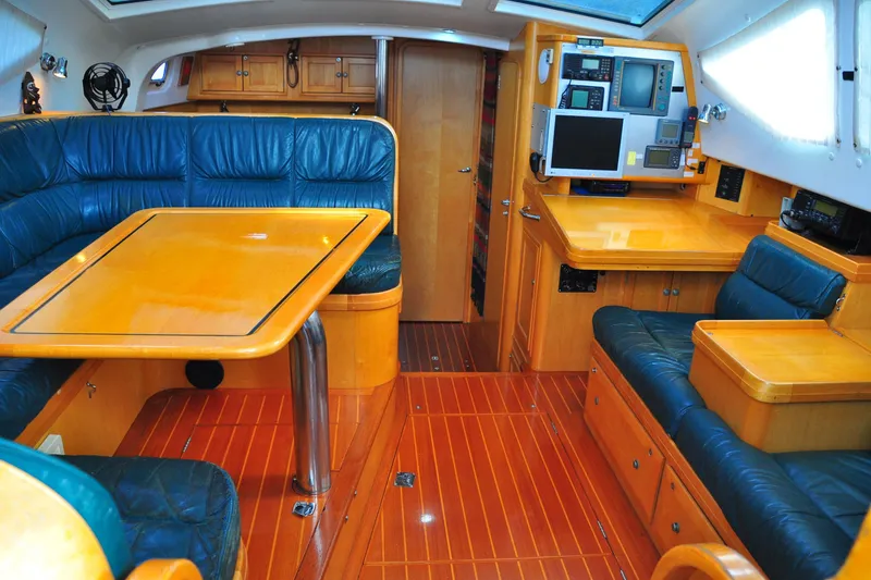 Raynad Yacht Photos Pics Luxurious interior of 2000 Custom Steel Cutter World Cruiser yacht with wood and leather furnishings.