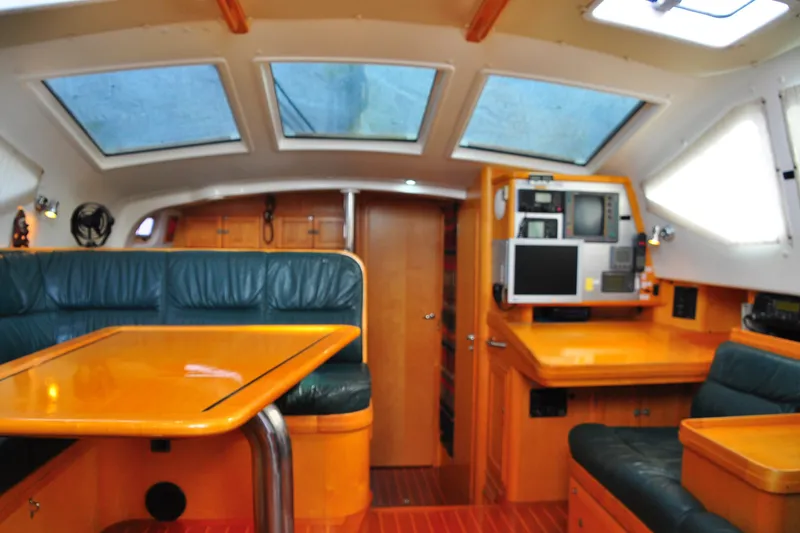 Raynad Yacht Photos Pics Interior of 2000 Custom Steel Cutter World Cruiser yacht with modern navigation equipment.
