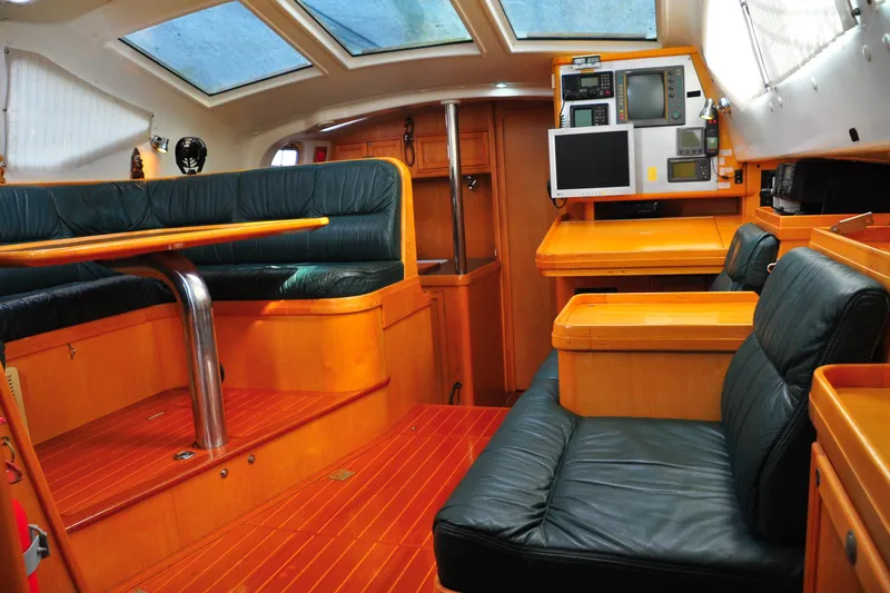 Raynad Yacht Photos Pics Luxurious interior of 2000 Custom Steel Cutter World Cruiser yacht with leather seating.