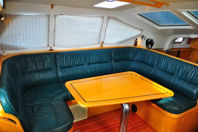 Raynad Yacht Photos Pics Luxurious interior of 2000 Custom Steel Cutter World Cruiser yacht with leather seating.