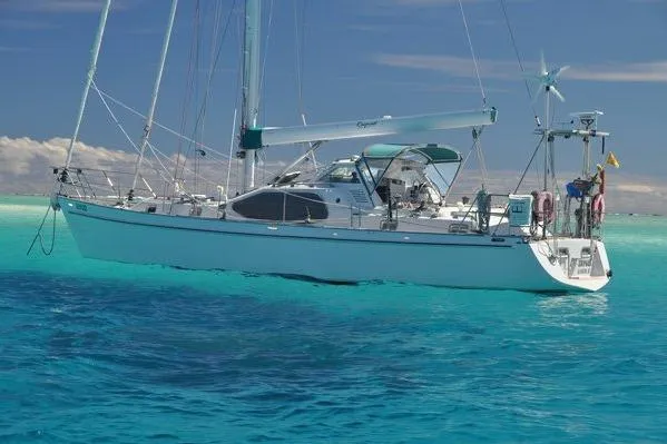 Raynad Yacht Photos Pics Sailing yacht "World Cruiser" by Custom Steel Cutter, 2000, on clear turquoise waters.