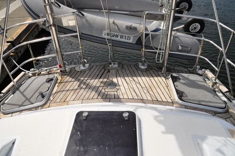 Raynad Yacht Photos Pics Deck of 2000 Custom Steel Cutter World Cruiser with dinghy and wooden flooring.