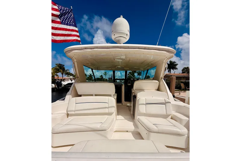 Lola Yacht Photos Pics 2005 Tiara Yachts 3600 Sovran with American flag, luxurious seating, and clear blue sky.
