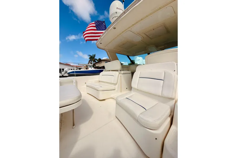 Lola Yacht Photos Pics 2005 Tiara Yachts 3600 Sovran interior with white seating and American flag.