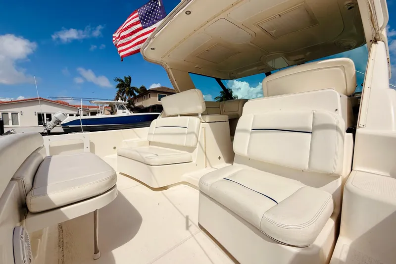 Lola Yacht Photos Pics 2005 Tiara Yachts 3600 Sovran interior with white seating and American flag.