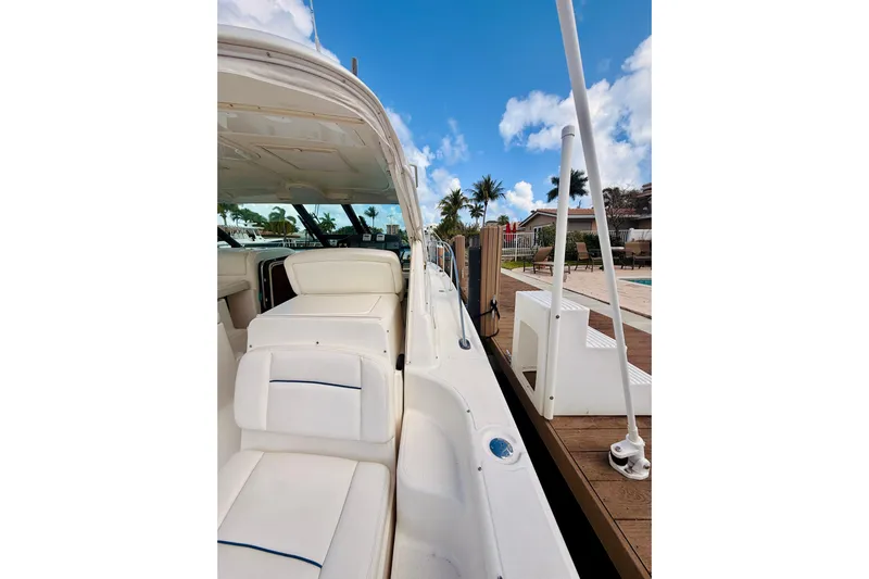 Lola Yacht Photos Pics 2005 Tiara Yachts 3600 Sovran docked, showcasing sleek white seating and clear blue skies.