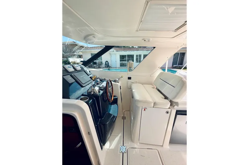 Lola Yacht Photos Pics 2005 Tiara Yachts 3600 Sovran helm with white seating and modern controls.