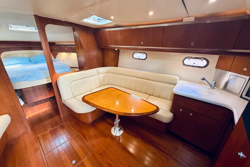 Lola Yacht Photos Pics Luxurious interior of 2005 Tiara Yachts 3600 Sovran with wood finish and cozy seating.