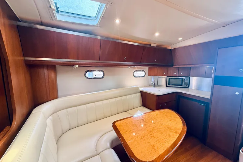 Lola Yacht Photos Pics Luxurious interior of 2005 Tiara Yachts 3600 Sovran with elegant seating and kitchenette.