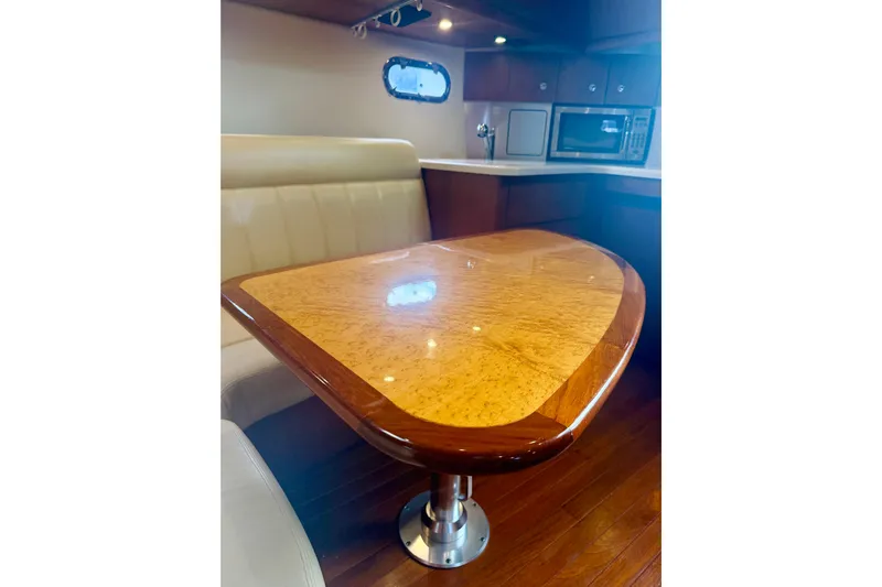 Lola Yacht Photos Pics Luxurious interior of 2005 Tiara Yachts 3600 Sovran with elegant wood table and seating.