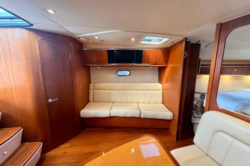 Lola Yacht Photos Pics Luxurious interior of 2005 Tiara Yachts 3600 Sovran with wood finish and cream seating.