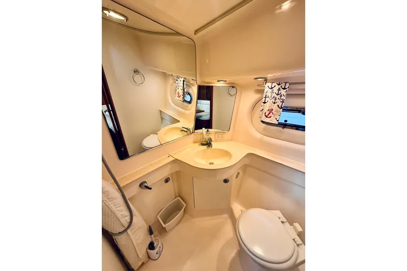 Lola Yacht Photos Pics Luxurious bathroom in 2005 Tiara Yachts 3600 Sovran, featuring modern fixtures and nautical decor.