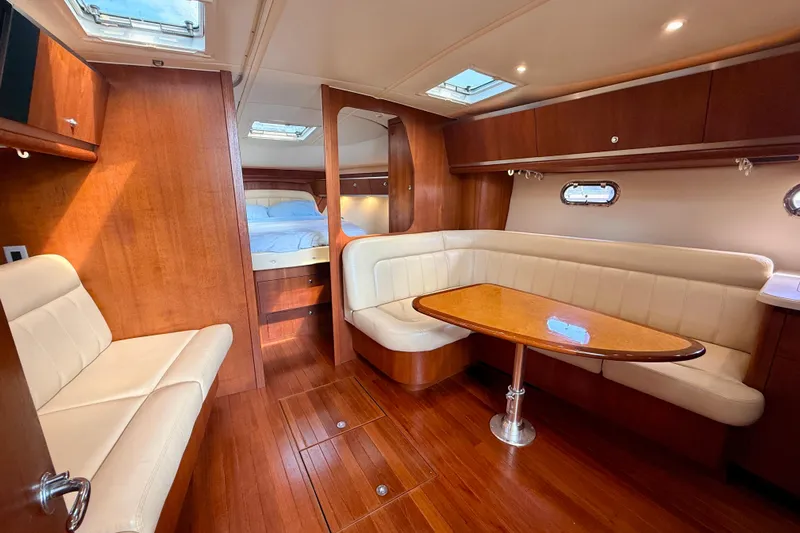 Lola Yacht Photos Pics 2005 Tiara Yachts 3600 Sovran interior with wood finish and cozy seating area.