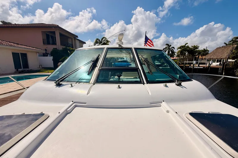 Lola Yacht Photos Pics 2005 Tiara Yachts 3600 Sovran docked, showcasing sleek design and American flag.