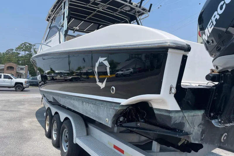  Yacht Photos Pics 2007 Fountain 38 Sportfish Cruiser OB on trailer, featuring sleek black and white design.