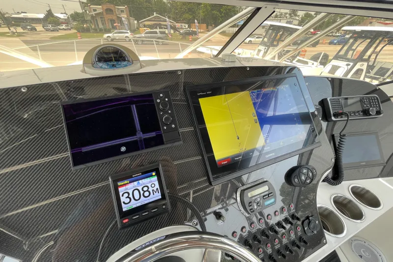  Yacht Photos Pics Dashboard of a 2007 Fountain 38 Sportfish Cruiser OB with navigation screens and controls.