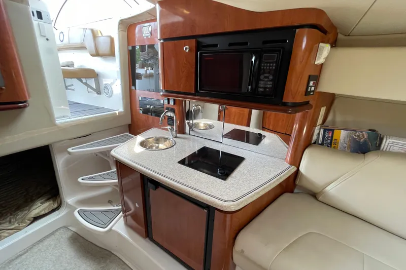  Yacht Photos Pics 2007 Fountain 38 Sportfish Cruiser OB interior with kitchenette, microwave, and seating area.