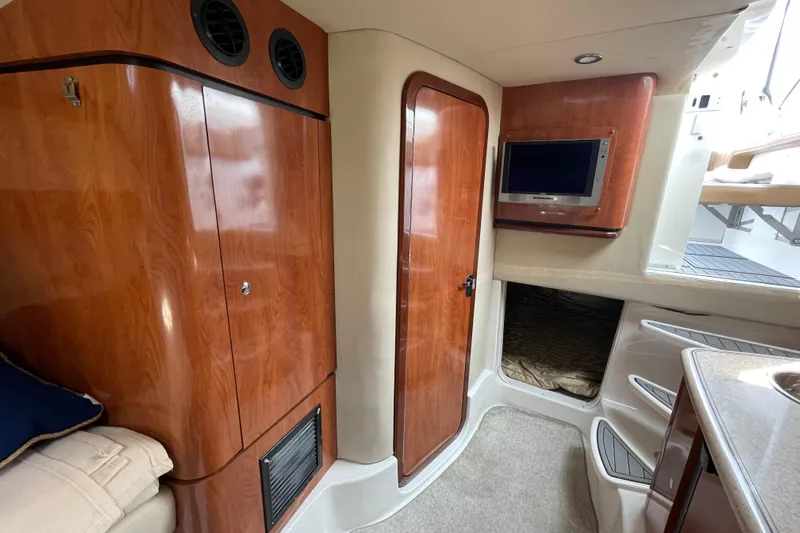  Yacht Photos Pics 2007 Fountain 38 Sportfish Cruiser OB interior with wood finish, TV, and cozy cabin space.