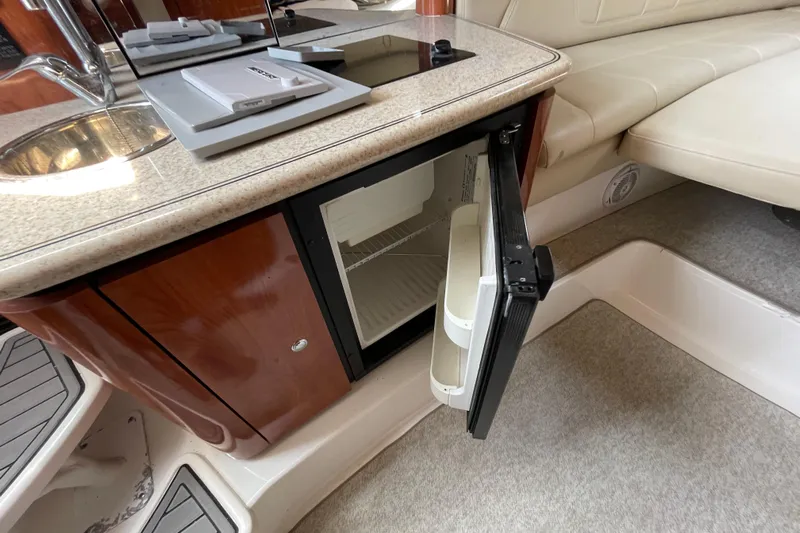  Yacht Photos Pics 2007 Fountain 38 Sportfish Cruiser OB interior with open mini fridge and sink.