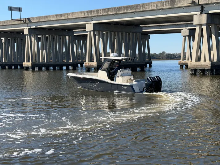  Yacht Photos Pics 2025 Scout 260 LXF boat under bridge on water.