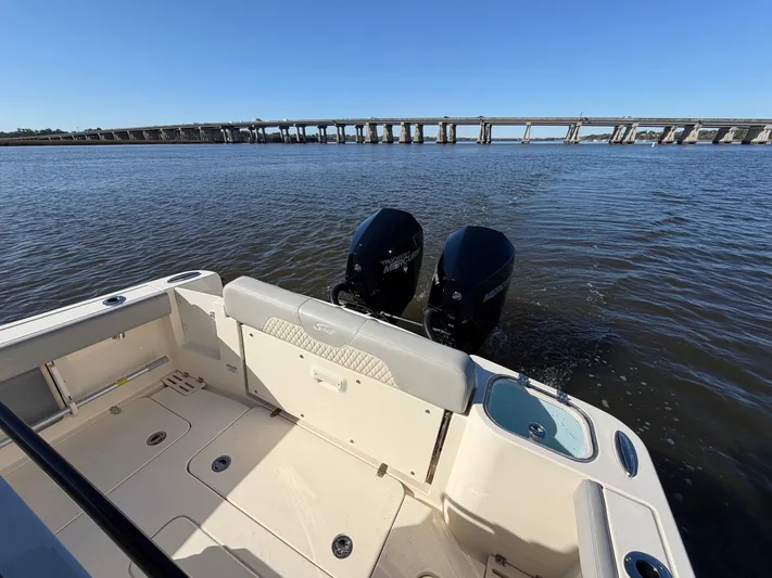  Yacht Photos Pics 2025 Scout 260 LXF boat on calm water with bridge in background.