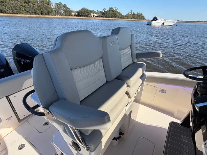  Yacht Photos Pics 2025 Scout 260 LXF boat with luxurious seating on calm waters.