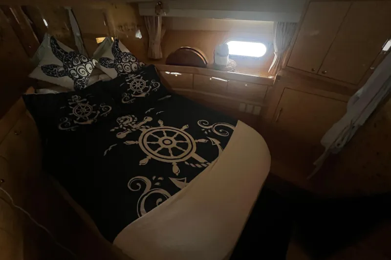  Yacht Photos Pics Cozy bedroom in 2001 Jefferson International 5300 yacht with nautical-themed bedding.