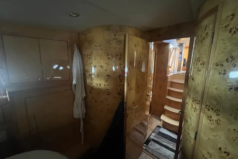  Yacht Photos Pics Luxurious interior of a 2001 Jefferson International 5300 yacht with wooden finishes and staircase.