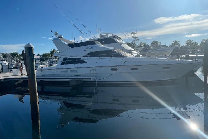  Yacht Photos Pics Luxury yacht Jefferson International 5300, 2001 model, docked at marina under clear blue sky.