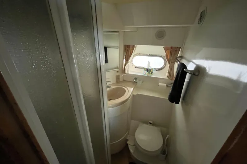  Yacht Photos Pics Compact bathroom in 2001 Jefferson International 5300 yacht with shower, sink, and toilet.