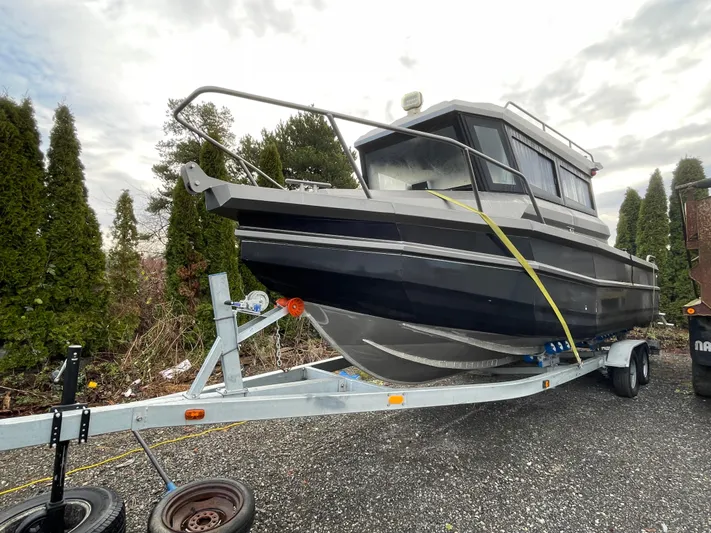  Yacht Photos Pics Custom 2022 aluminum fishing boat on trailer, parked outdoors.