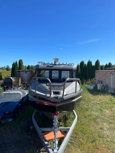  Yacht Photos Pics Custom 2022 aluminum fishing boat on trailer, parked outdoors under clear blue sky.