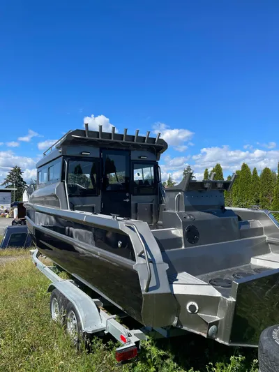  Yacht Photos Pics Custom 2022 aluminum fishing boat on trailer under clear blue sky.