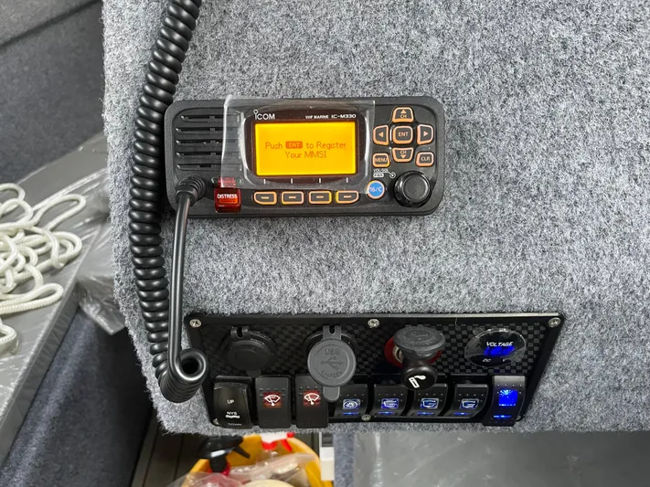  Yacht Photos Pics Control panel of a 2022 Custom Aluminum Fishing boat with radio and switches.