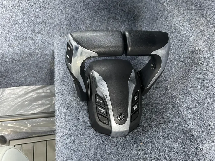  Yacht Photos Pics Steering wheel of a 2022 Custom Aluminum Fishing boat on gray carpet.