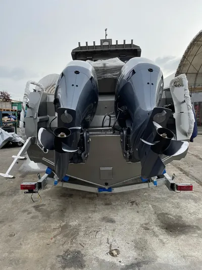  Yacht Photos Pics 2022 Custom Aluminum Fishing boat with dual outboard motors, parked outdoors.