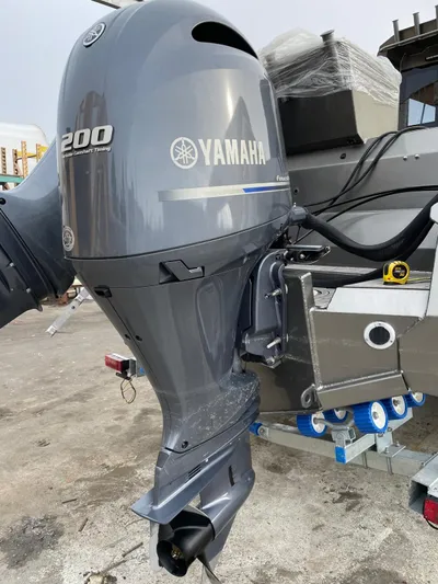  Yacht Photos Pics 2022 Custom Aluminum Fishing boat with Yamaha 200 outboard motor, docked on a trailer.