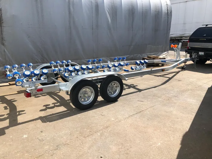 Yacht Photos Pics Custom 2022 aluminum fishing boat trailer with dual axles and blue rollers.