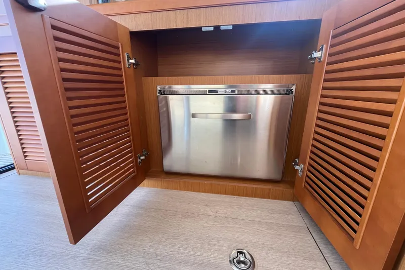  Yacht Photos Pics 2019 Beneteau Swift Trawler 35 interior with stainless steel appliance in wooden cabinet.