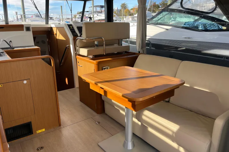  Yacht Photos Pics 2019 Beneteau Swift Trawler 35 interior with dining area and helm station.