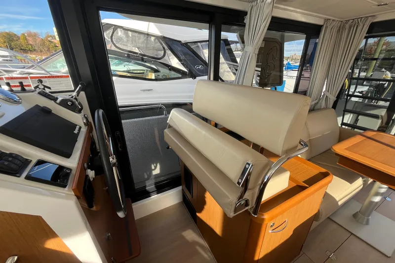  Yacht Photos Pics Interior of 2019 Beneteau Swift Trawler 35, featuring helm and seating area.