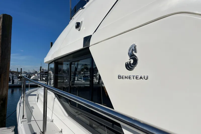  Yacht Photos Pics 2019 Beneteau Swift Trawler 35 docked, showcasing sleek design and logo.