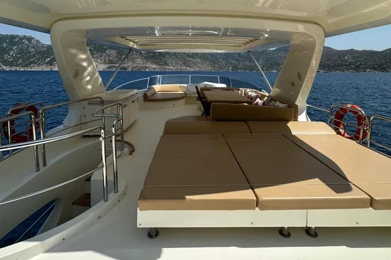  Yacht Photos Pics Luxurious 2012 Azimut 78 yacht deck with sun loungers, overlooking serene ocean waters.