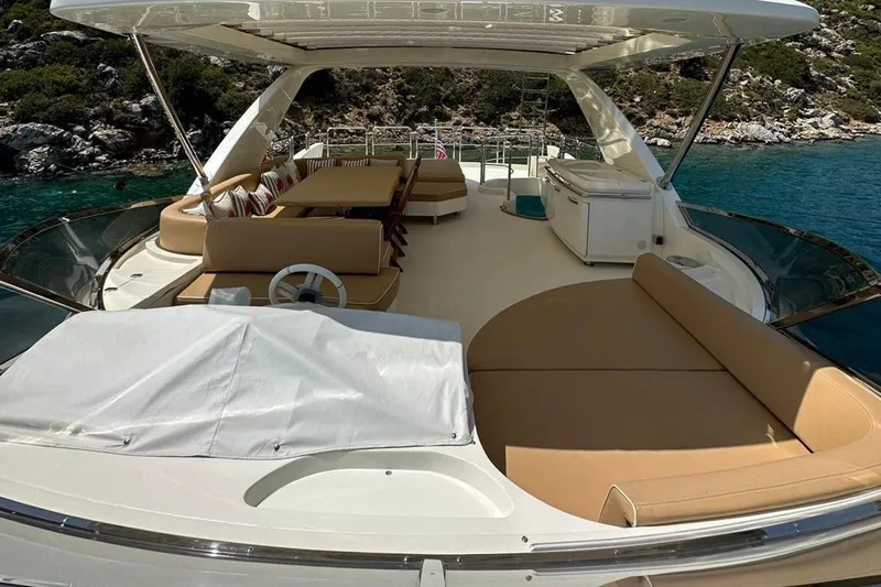 Yacht Photos Pics Luxurious 2012 Azimut 78 yacht deck with seating, overlooking serene waters and lush greenery.