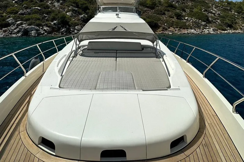  Yacht Photos Pics Luxurious 2012 Azimut 78 yacht with spacious sun deck, docked by clear blue waters.