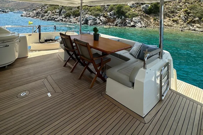  Yacht Photos Pics Luxurious 2012 Azimut 78 yacht deck with dining area, overlooking serene turquoise waters.