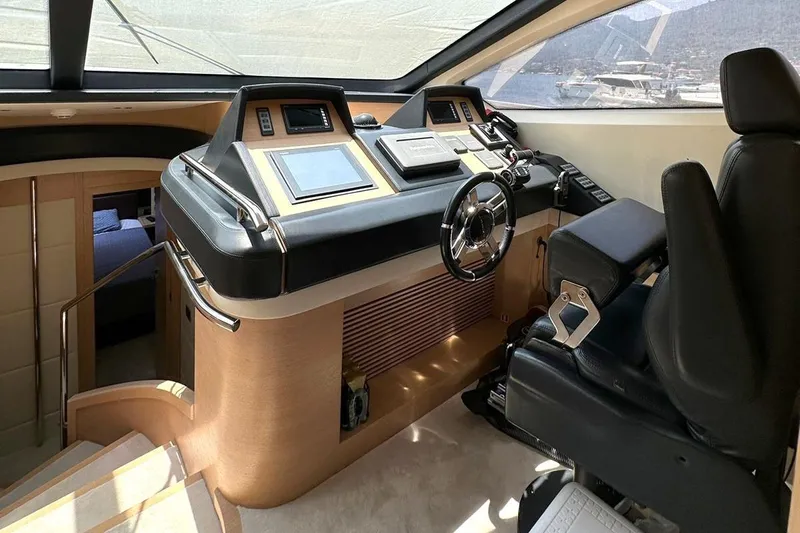  Yacht Photos Pics Luxurious 2012 Azimut 78 yacht helm with modern controls and leather seating.