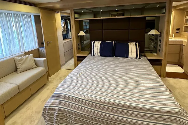  Yacht Photos Pics Luxurious bedroom interior of 2012 Azimut 78 yacht with striped bedding and cozy seating area.