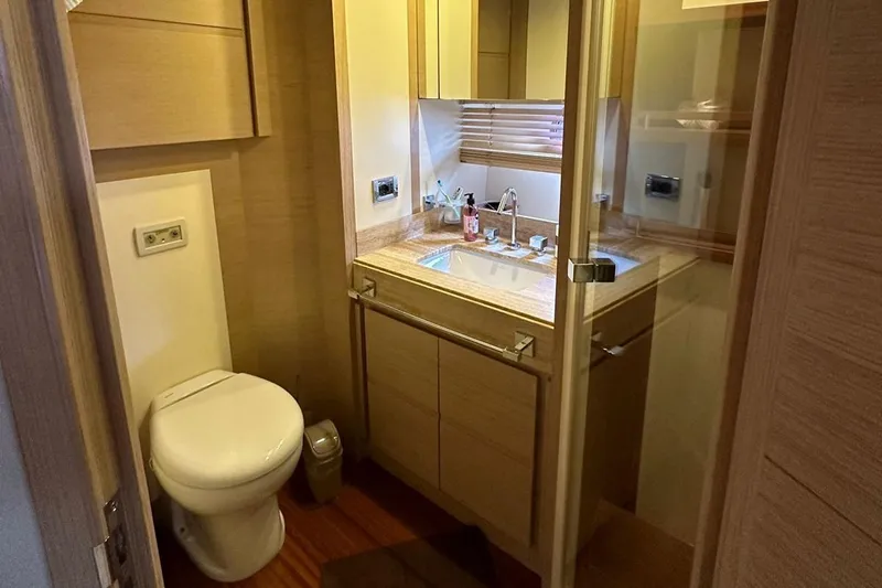  Yacht Photos Pics Luxurious bathroom in 2012 Azimut 78 yacht with modern fixtures and wooden accents.